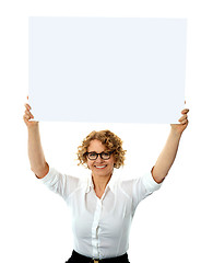 Image showing Happy woman holding blank billboard