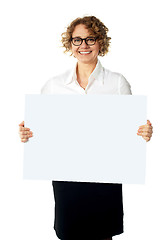 Image showing Caucasian businesswoman holding a blank billboard