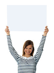 Image showing Cute girl lifting blank placard high