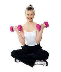 Image showing Young girl lifting weights