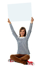 Image showing Girl holding blank billboard in upward direction