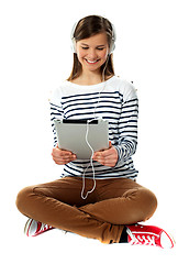 Image showing Girl watching video on her tablet