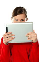 Image showing Beautiful girl hiding her face with touch pad