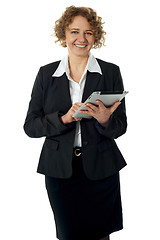 Image showing Curly haired corporate woman posing with ipad