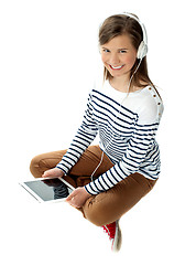 Image showing Pretty girl enjoying music on headphones