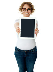 Image showing Woman showing tablet screen to camera