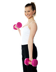 Image showing Strong teenager working out with dumbbells