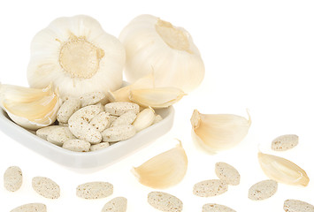 Image showing Garlic and herbal supplement pills isolated, alternative medicine concept