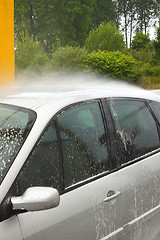 Image showing a car wash with a jet of water and shampoo