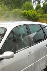 Image showing a car wash with a jet of water and shampoo