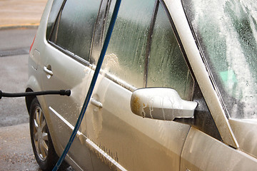 Image showing a car wash with a jet of water and shampoo