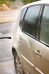 Image showing a car wash with a jet of water and shampoo