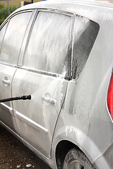 Image showing a car wash with a jet of water and shampoo