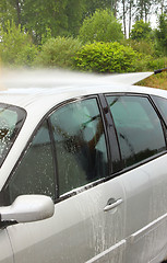 Image showing a car wash with a jet of water and shampoo