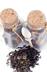Image showing Tea leaves in transparent parisons with wooden spoon