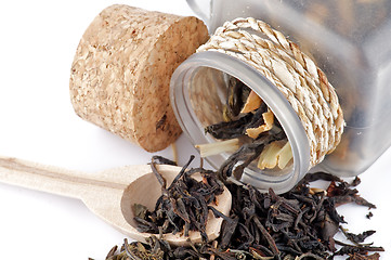 Image showing Tea leaves in transparent parison with wooden spoon