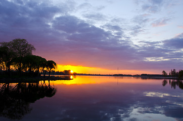 Image showing summer lake sunset. Boats sky reflections water 