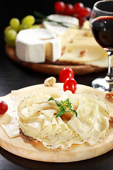 Image showing Cheese and salami platter with herbs