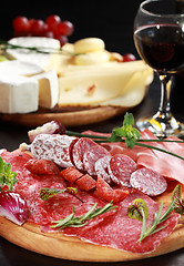 Image showing Salami and cheese platter with herbs