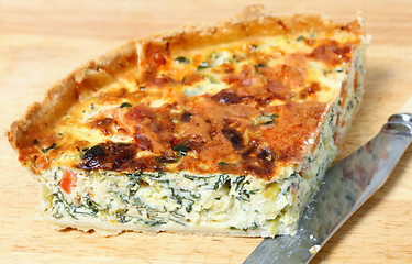 Image showing spinach quiche on a board