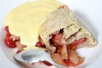 Image showing Pouring custard on fruit pudding