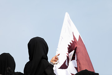 Image showing Covered women and Qatar flag