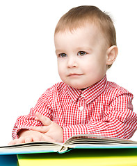 Image showing Little child play with book