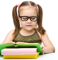 Image showing Cute little girl reading book