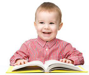 Image showing Little child play with book