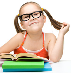 Image showing Cute little girl with books