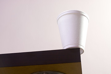 Image showing Cup on table edge

