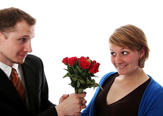 Image showing Man gives a bunch of flowers to a women