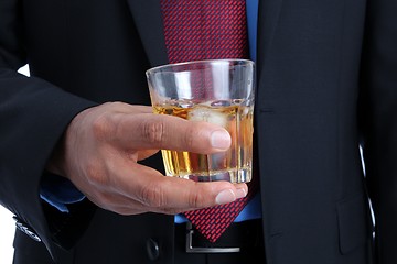 Image showing Businessman with a drink in his hand