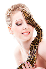 Image showing Beautiful woman holding python on isolated white