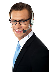 Image showing Smiling telemarketing male executive, closeup shot