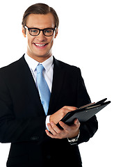 Image showing Caucasian smiling young businessman holding a folder