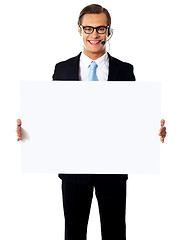 Image showing Smiling male operator with blank billboard