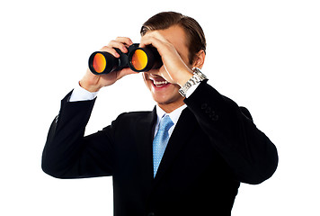 Image showing Business professional looking through binoculars