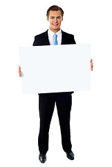 Image showing Portrait of businessman showing blank signboard