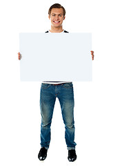 Image showing Full length view of man showing blank signboard