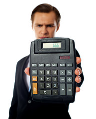 Image showing Businessman holding a calculator