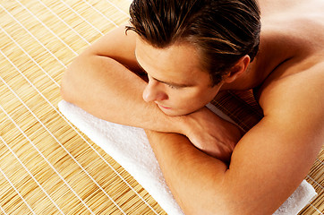 Image showing Man relaxing in a spa resort on mat