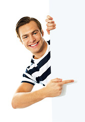 Image showing Handsome person pointing towards blank signboard