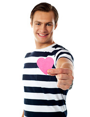 Image showing Young man ofering his paper heart to you