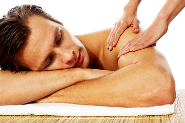 Image showing Attractive man having massage in a spa center