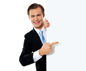 Image showing Business person pointing towards blank signboard