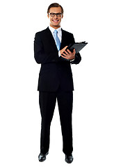Image showing Full length view of relaxed businessman holding a folder