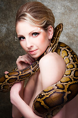 Image showing Attractive nude blond woman with python on grey