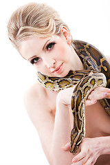 Image showing Beautiful woman holding Python on isolated white