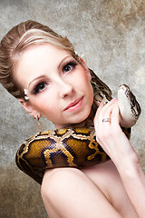 Image showing Attractive nude blond woman with python on grey